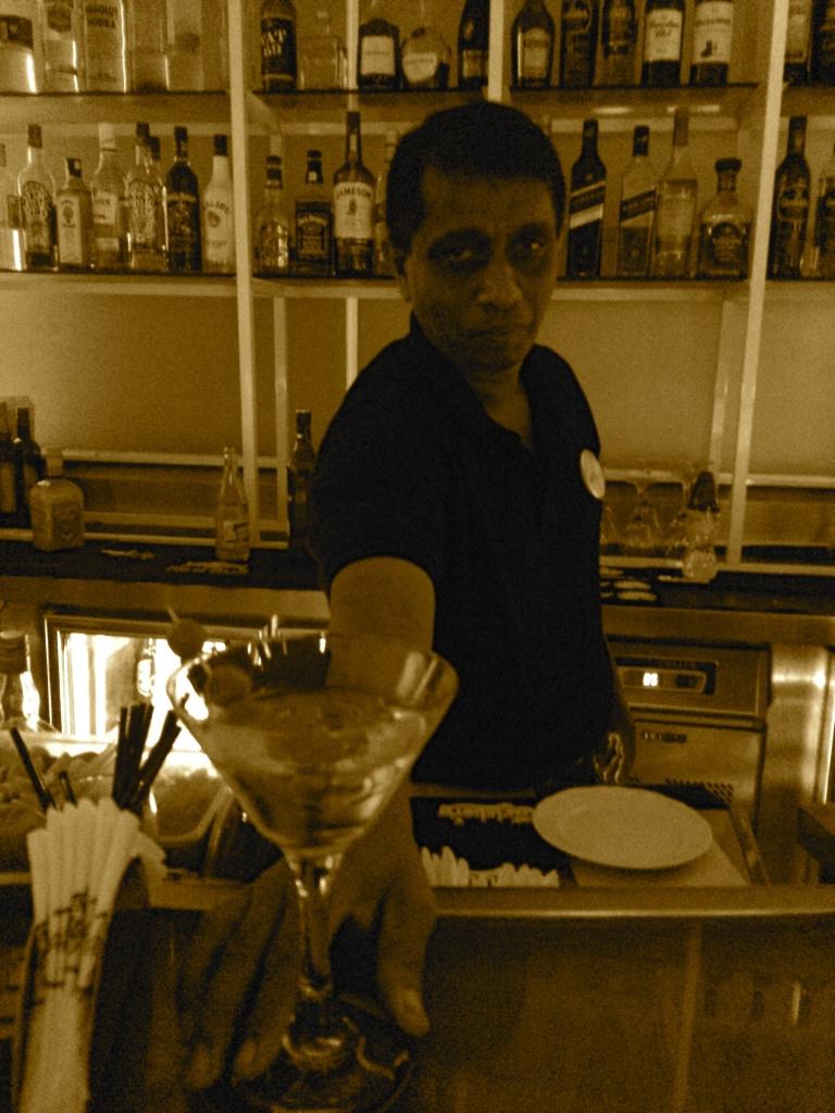 Priyantha the bartender serves up a martini